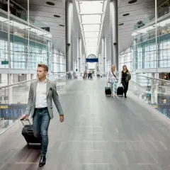 Man med resväska på en flygplats, kanske på väg till ett tåg till Fredrikshamn eller Aalborg.