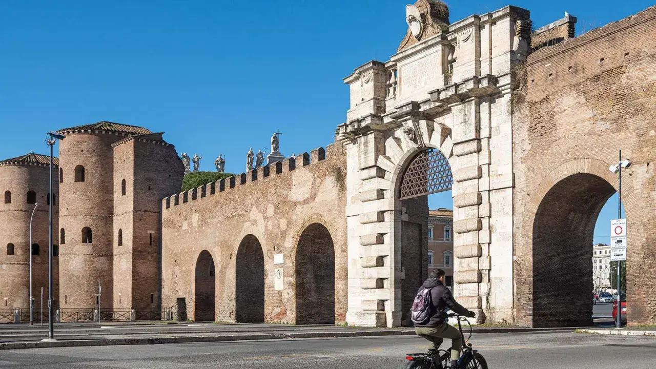 En cyklist passerar Porta San Sebastiano, en del av det antika kvarteret i Rom.