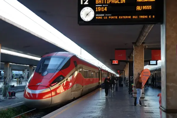 Rött höghastighetståg på en station, redo för avgång till Sicilien.